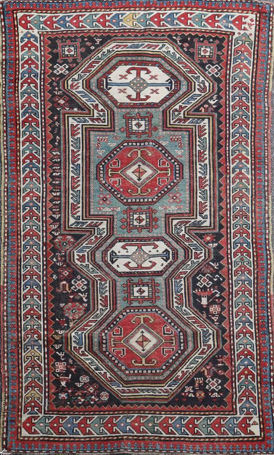 An antique Caucasian polychrome ground rug, 7ft 5in by 4ft 4in.